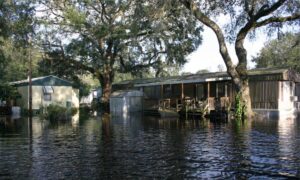 Flooded homes surrounded by water showing why a flood elevation certificate and NOAA flood maps are important