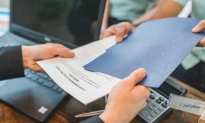 Real estate documents being reviewed before ordering a property survey